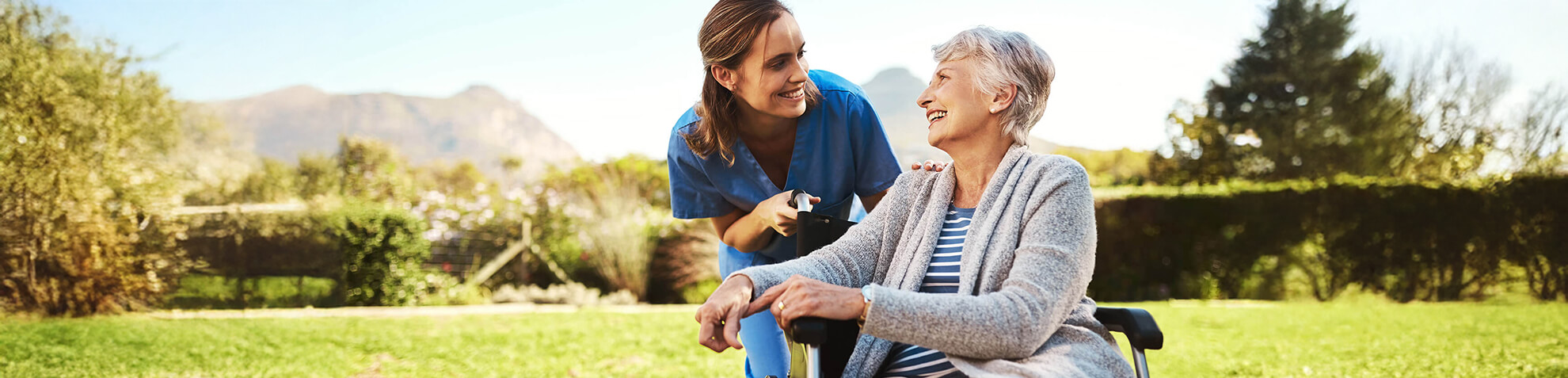 a healthcare professional providing aged care assistance to an elderly woman on a wheelchair in Sydney Eastern Suburbs